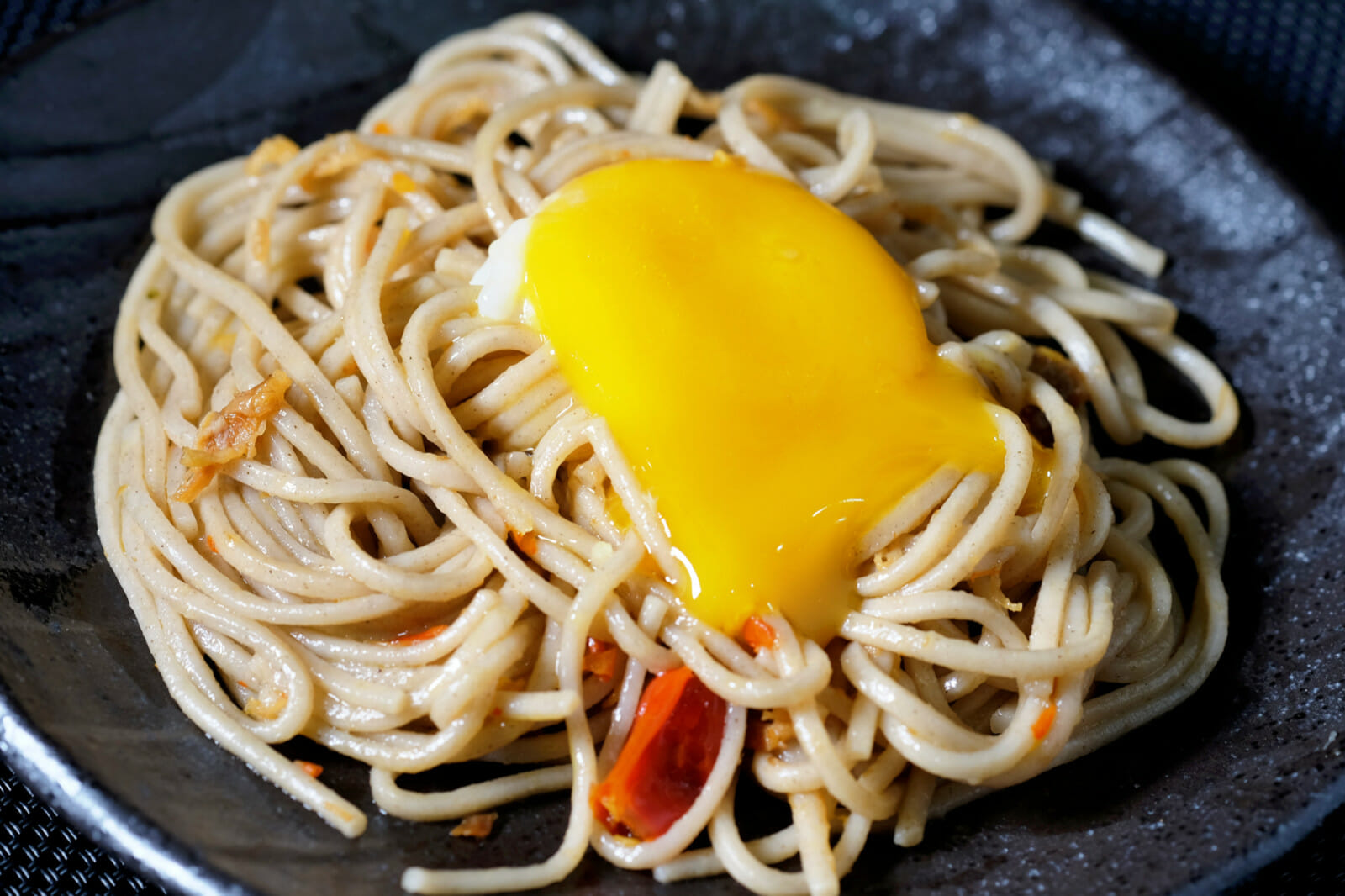 Spicy soba noodles with XO sauce and confit egg yolk delectabilia