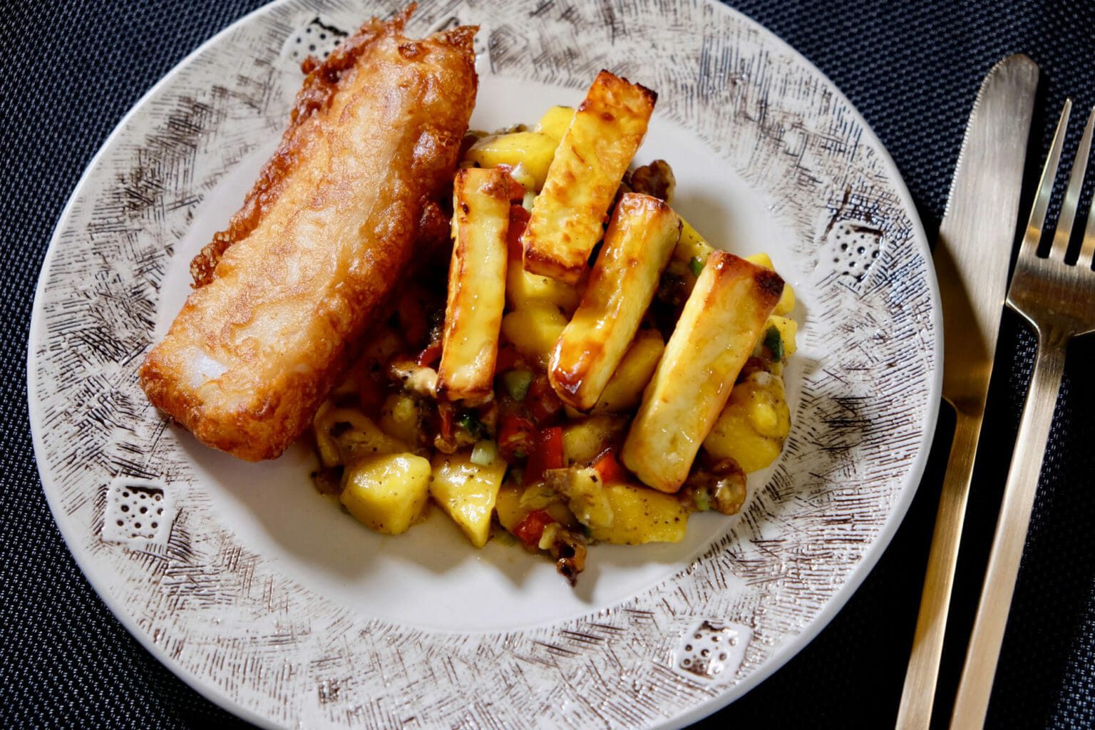 Beer battered fish and halloumi chips with mango walnut salad