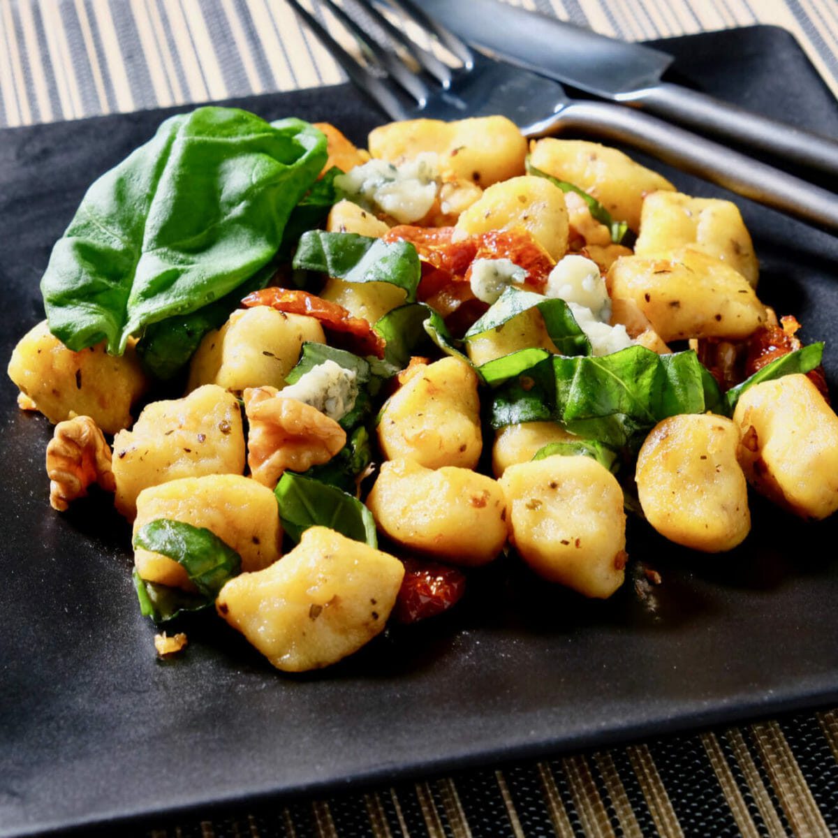 Panseared gnocchi, sundried tomatoes, basil, and walnuts