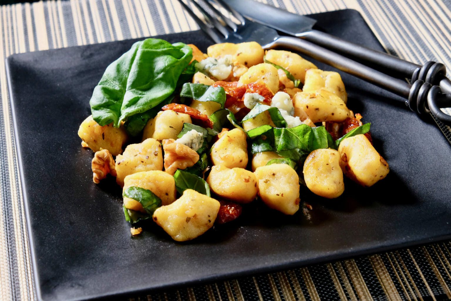 Panseared gnocchi, sundried tomatoes, basil, and walnuts