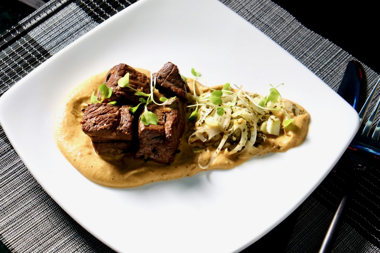 Grilled lamb loin on a roasted eggplant and garlic puree delectabilia