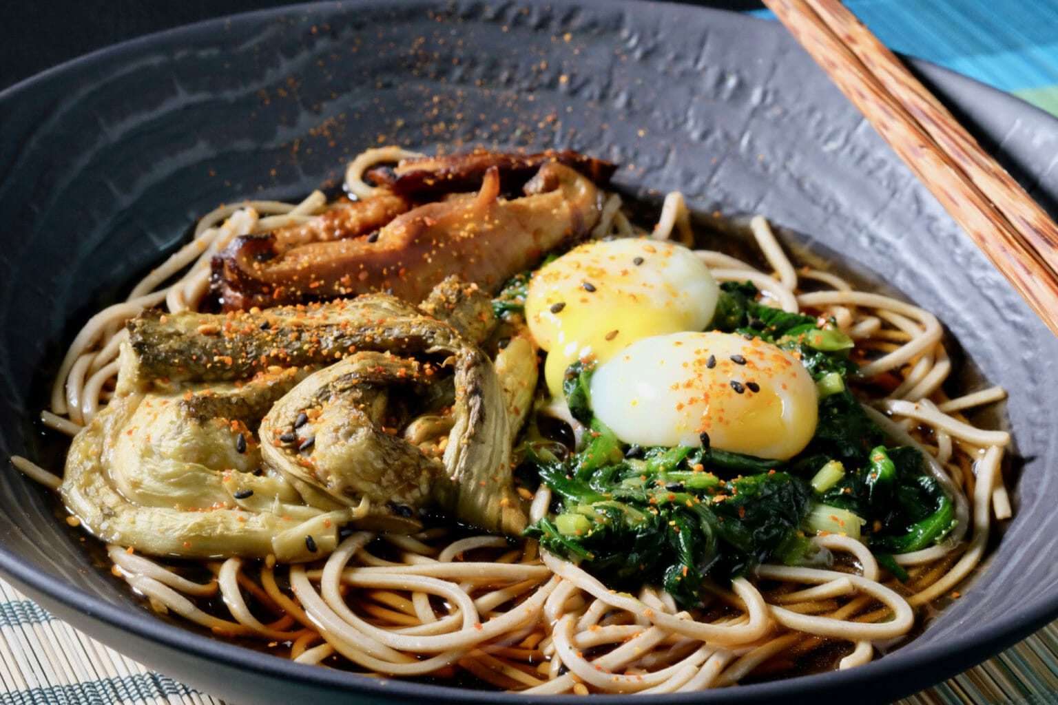 Soba noodles with grilled eggplant, spinach, and quail eggs delectabilia