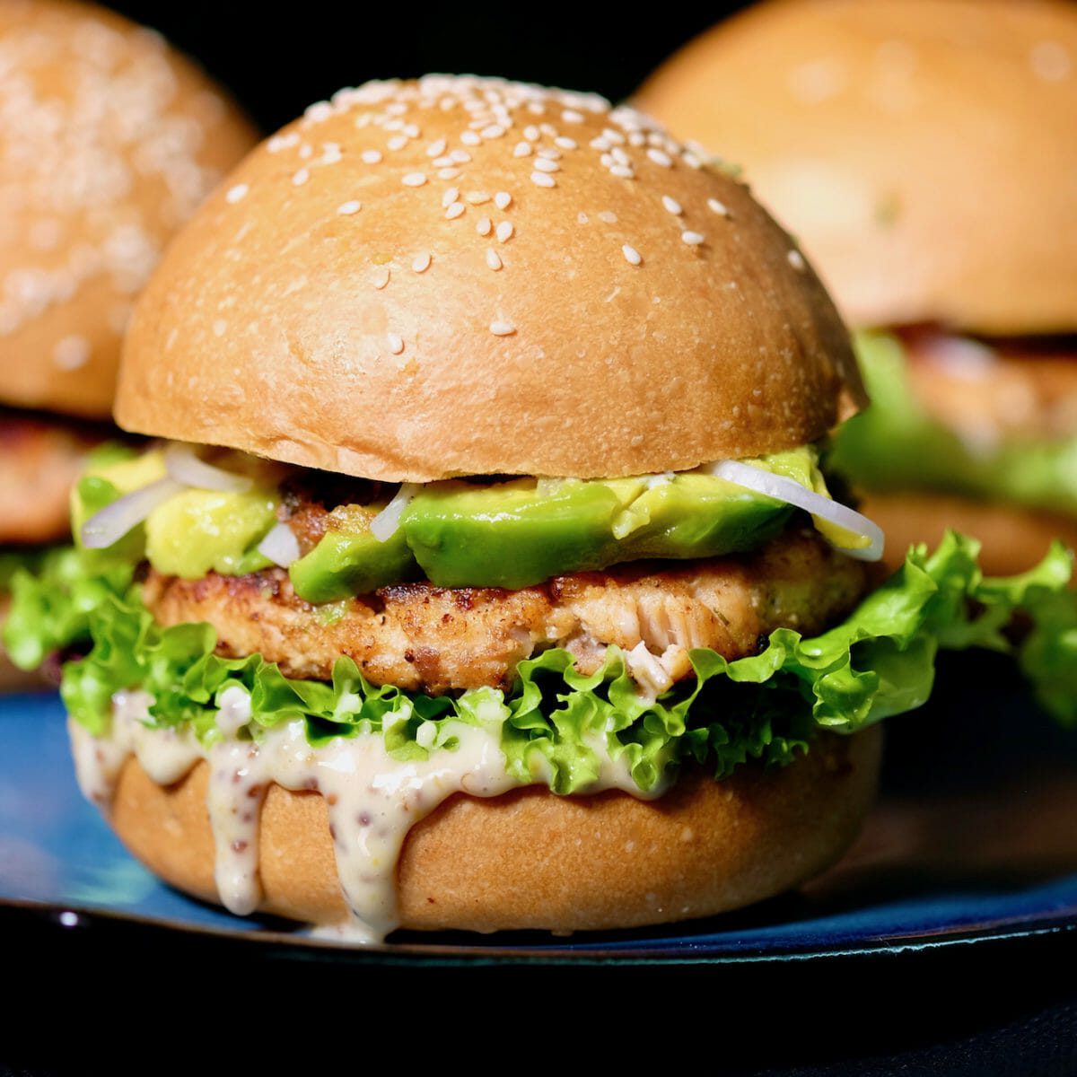 Salmon avocado burger with a honey mustard mayo delectabilia