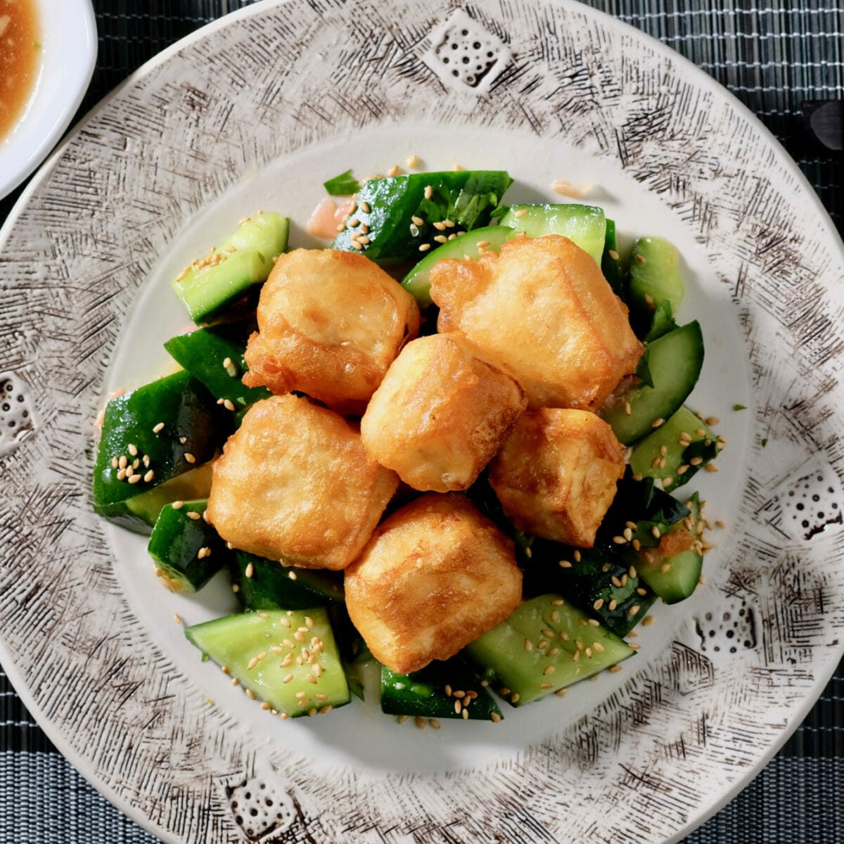 Tempura tofu on smashed cucumber with sesame oil and ginger delectabilia